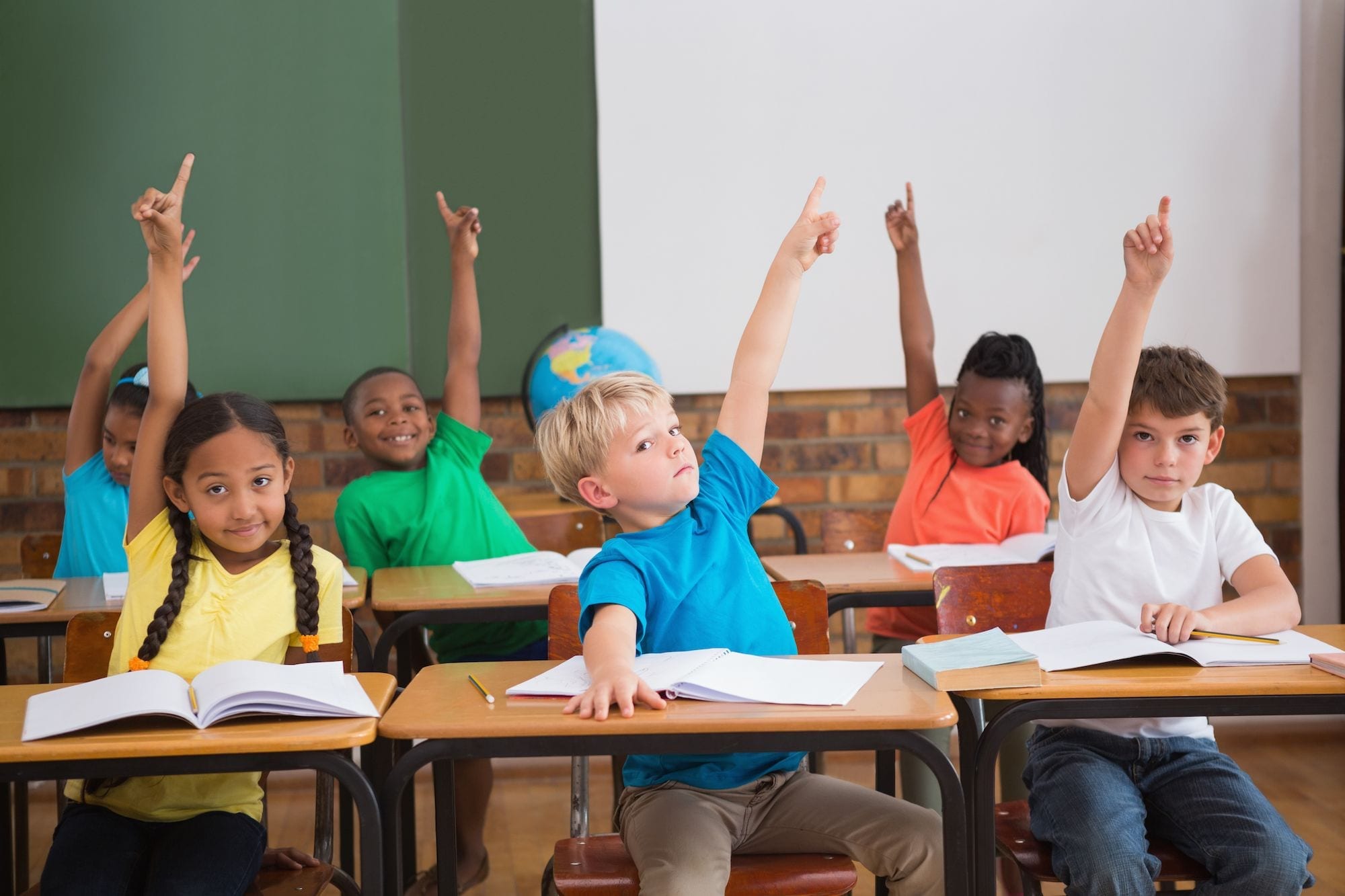 Kids in class raising their hands