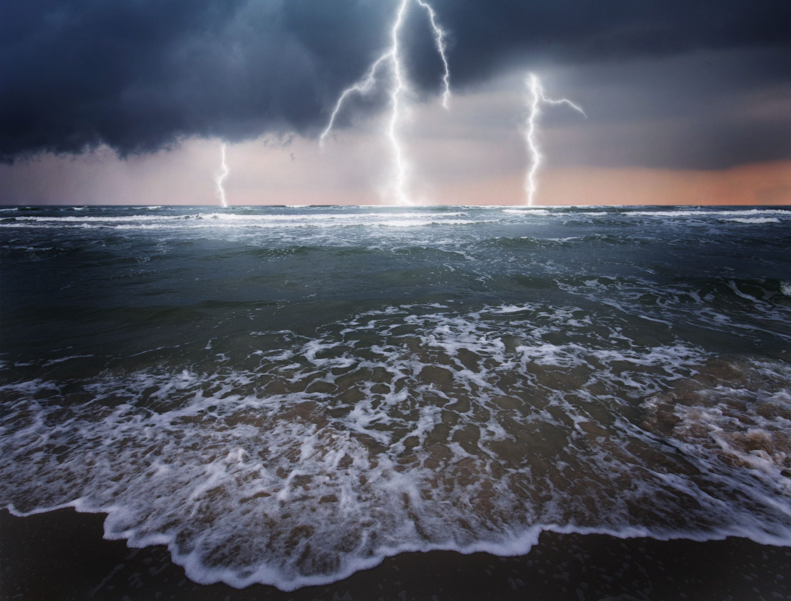 Lightning strikes on the ocean viewing from the beach