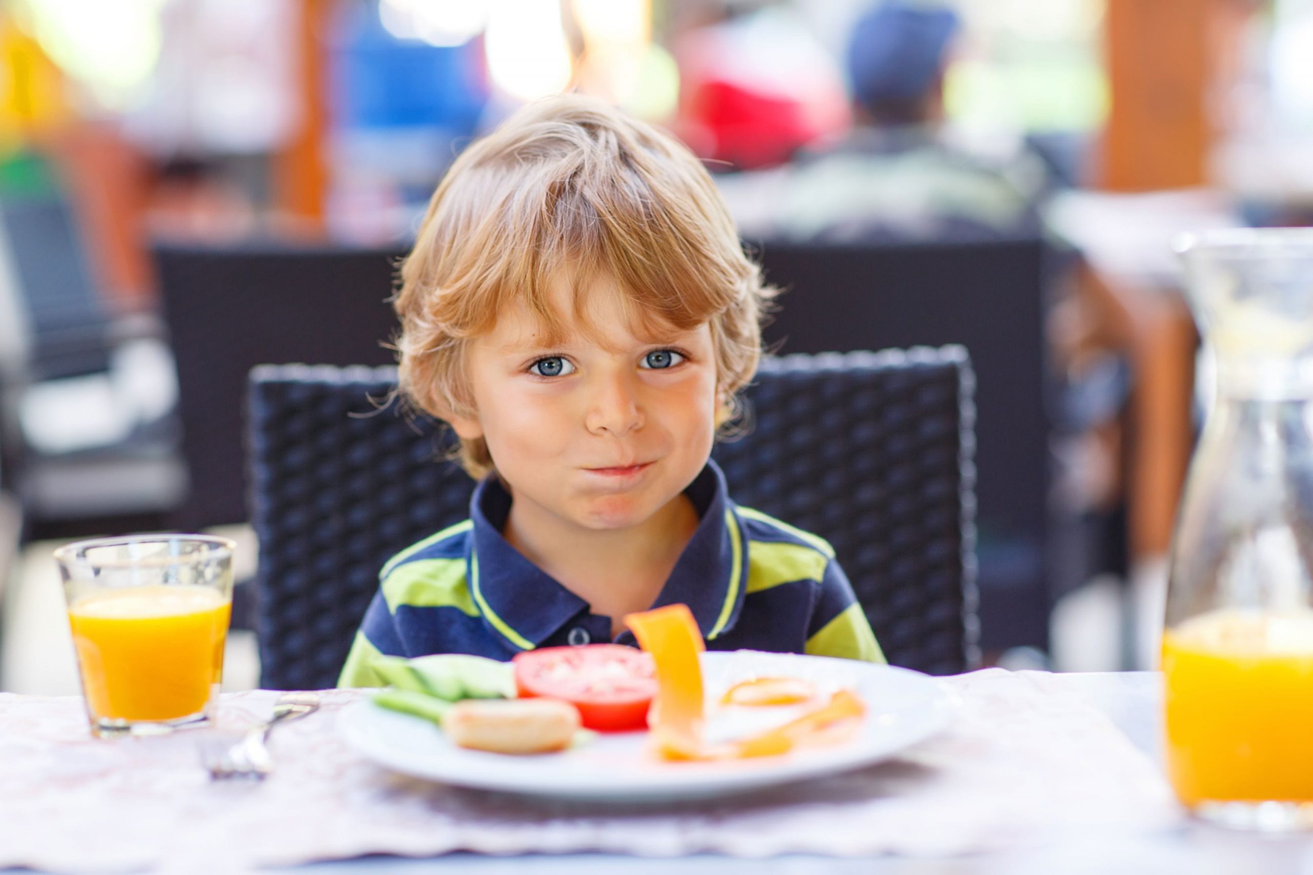 Little boy eating in a restaurant
