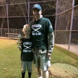 Dr. Dietrich and his son holding a baseball trophie
