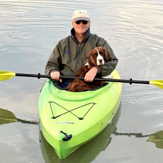 Dr. Ball and his dog kayaking on the water