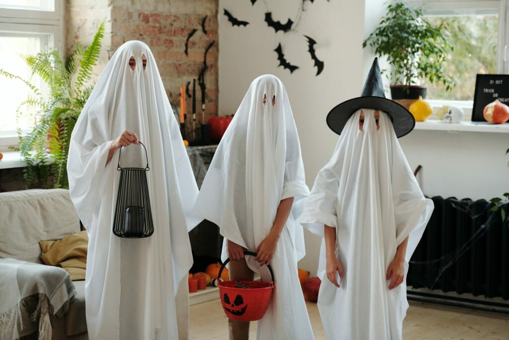Family dressed as ghosts for Halloween.